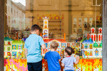 Conceptual Photography Of Children Outside The Shop With Sweets. Storefront Caramel Products. Candy Shop.