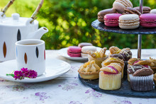 Tea With Cakes And Macaroons Set Up In The Garden