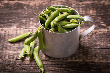 green peas on wooden table ,healthy concept