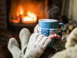 © volff - Warming and relaxing near fireplace with a cup of hot drink.