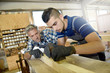 © goodluz - Carpenter with apprentice in training period