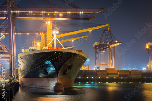 Fotografía Container Cargo freight ship with working crane bridge in shipyard at dusk for Logistic Import Export background