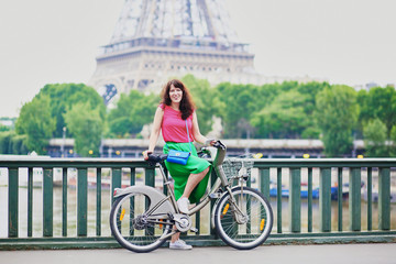 Canvas Print - Woman riding a bicycle on a street of Paris