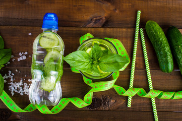 Poster - Dietary cocktail of cucumber and mint leaves on a wooden background