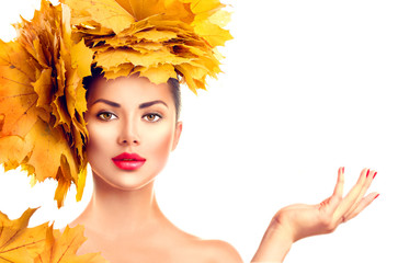 Wall Mural - fall. beauty model girl with autumn bright leaves hairstyle. girl showing empty copy space on open h