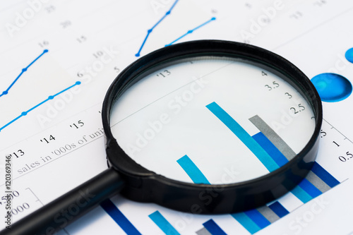 Fotografía Business Analysis Image - magnifying glass on graphs and spreadsheet