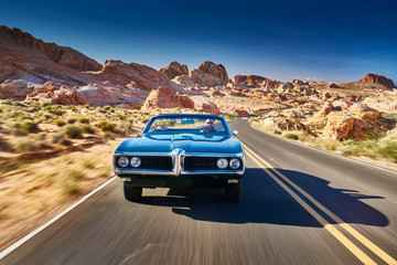 guy driving cool vintage car through nevada desert