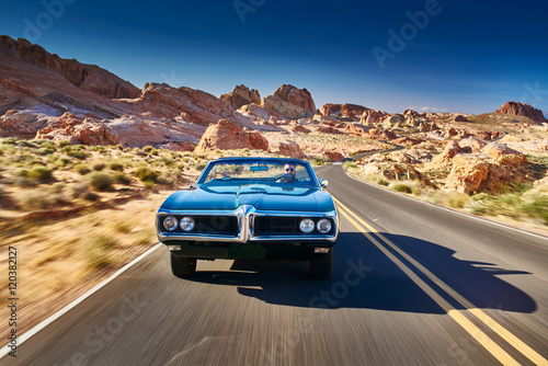 Cuadros en Lienzo guy driving cool vintage car through nevada desert