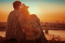 Young Couple Enjoying The Sunset