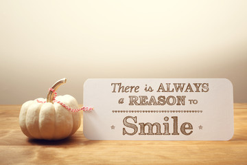 There is Always a Reason to Smile message with small pumpkin