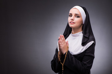 Religious nun in religion concept against dark background