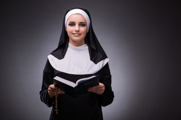 Religious nun in religion concept against dark background