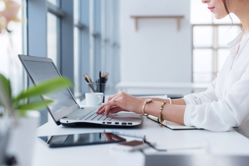 side view portrait of woman working in home-office as teleworker, typing and surfing internet, havin