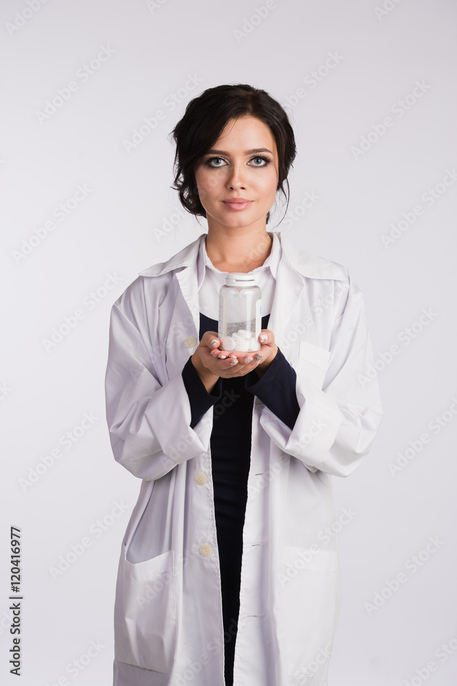 Beautiful young brunette female nurse or physician with glasses in blue ...