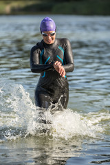 Wall Mural - Sportive girl runs on the water