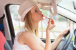 Woman applying makeup while driving her car
