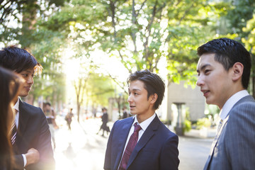 Wall Mural - Four of the young business man is talking in the office district