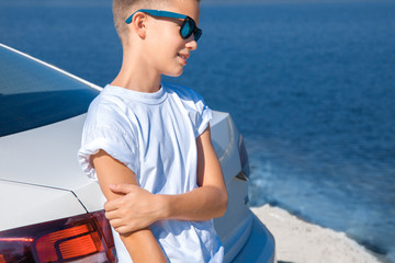 stylish young boy in sunglasses