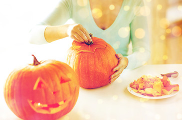 Wall Mural - close up of woman with pumpkins at home