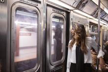 Businesswoman Looking Through Window While Traveling In Subway Train