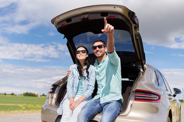 Wall Mural - happy couple hugging at open hatchback car trunk