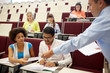 © Syda Productions - teacher giving tests to students at lecture