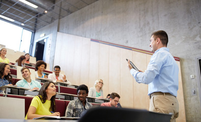 students and teacher with tablet pc at lecture
