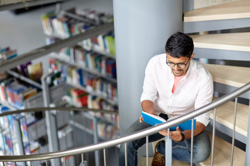 Canvas Print - hindu student boy or man reading book at library