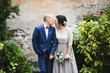 © andriychuk - Beautiful luxury newlyweds posing outside