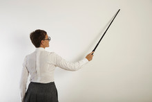 Female Teacher With A Pointer At White Board