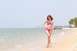 © chaiviewfinder - Beautiful women in bikinis strolling happily along the beach.