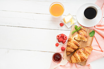 breakfast time with croissants and coffee on wooden table