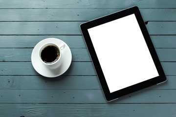 digital tablet and coffee cup on wooden table