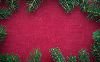 Wall Mural - frame with xmas tree on red canvas background. merry christmas card. winter holiday theme. space for