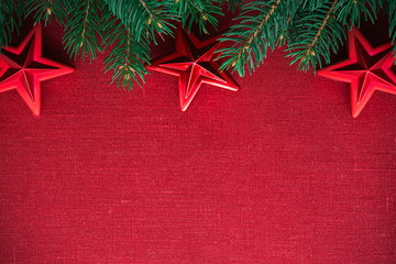 Wall Mural - frame with xmas tree and ornaments on red canvas background. merry christmas card. winter holiday th