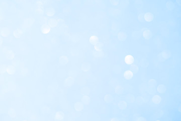 Wall Mural - Unfocused abstract light blue glitter bokeh holiday background. Winter xmas holidays. Christmas.