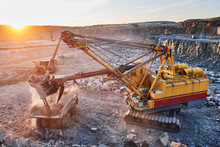 Mining. Excavator Loading Granite Or Ore Into Dump Truck
