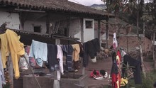 Children Playing On The Floor On A Poor Neighborhood With Hanged Clothes On The Ecuadorian Valleys. 4k