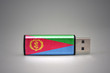 usb flash drive with the national flag of eritrea on gray background.