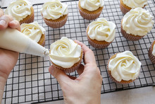Piping Rose Flower Frosting On Vanilla Cupcakes