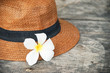 © Ratana21 - plumeria flower on woven hat , in soft focus