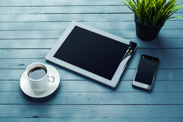 Poster - digital tablet and coffee cup on wooden table