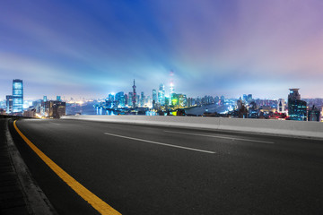 cityscape and skyline of shanghai from empty asphalt road