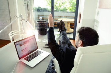 business man playing basket in office with legs on desk