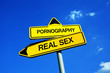 Pornography vs Real Sex - Traffic sign with two options -  appeal to fight against exaggerated pornographic material and risk of addiction and unrealistic expectation about reality and sex life