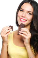 Beautiful smiling girl holding and eating chocolate isolated on white