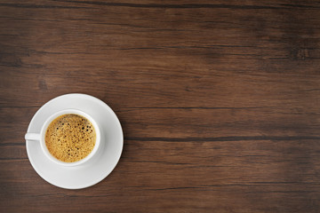 Wall Mural - Cup of coffee on wooden background