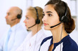 © rogerphoto - Call center. Focus on beautiful woman in headset