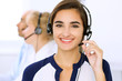 © rogerphoto - Call center. Focus on beautiful woman in headset