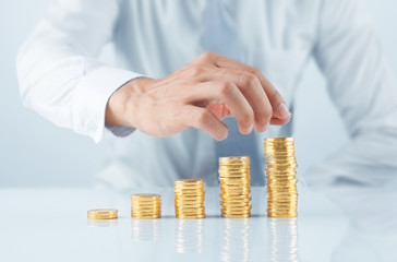 Hand putting stack of coins